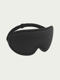 A black sleep mask with a curved design and adjustable strap is centered against a light gray background, conveying comfort and relaxation.