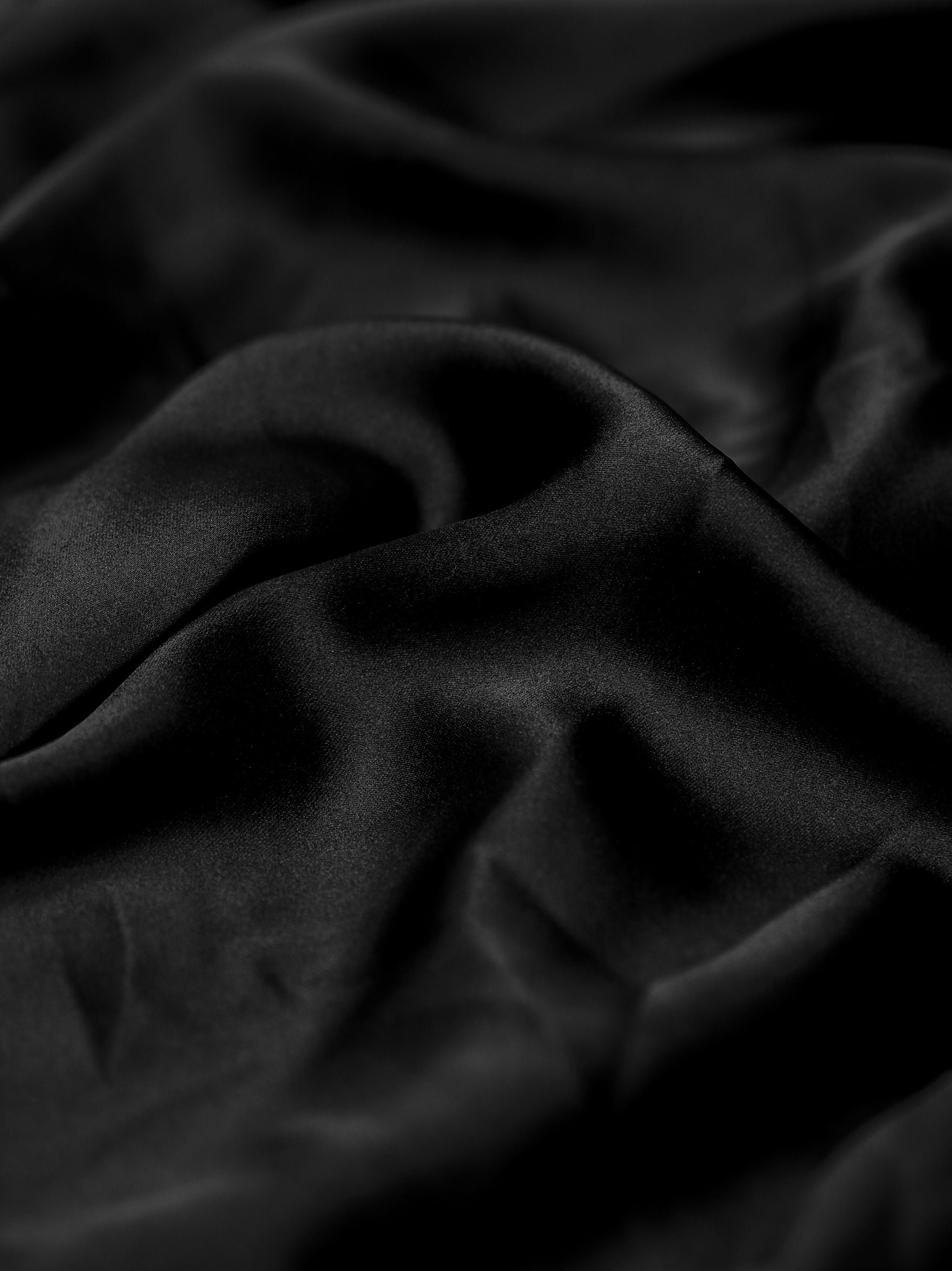 Close-up of black fabric with folds